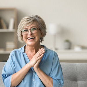 Woman sitting on couch smiling